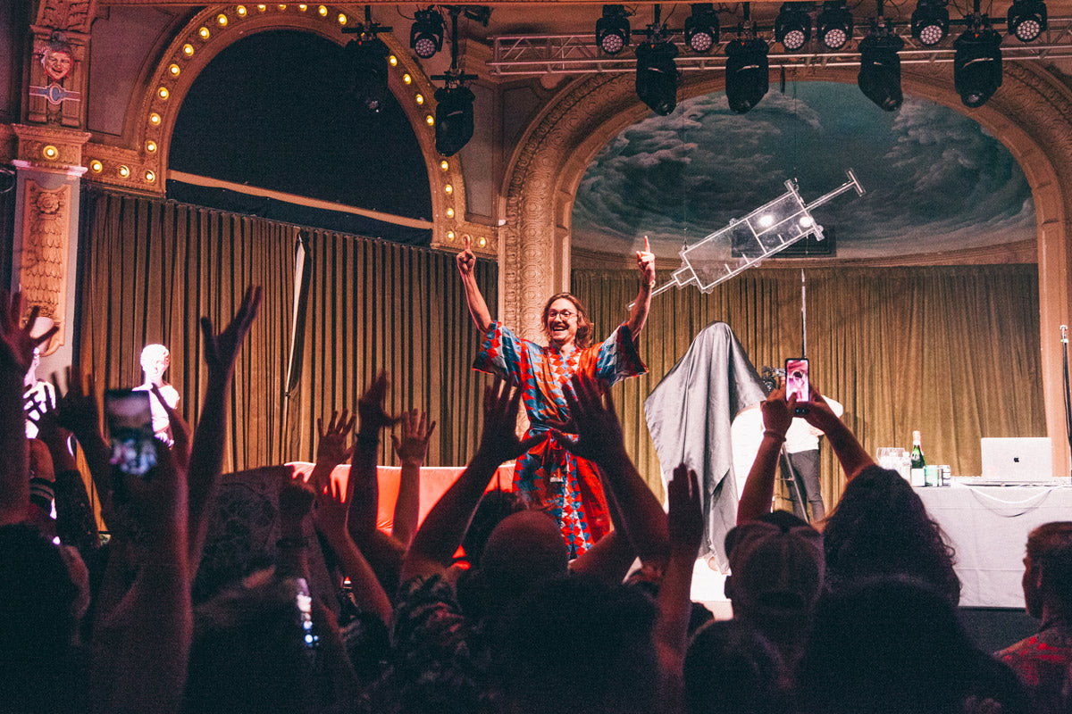 Loop daddy Marc Rebillet wearing red kimono on tour