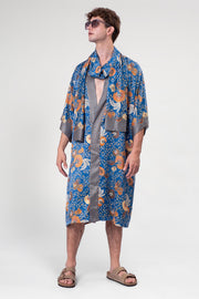 Model wearing Birds and Bees Full-Length Kimono by Rafikimono, featuring a bright blue print inspired by spring's lively nature.