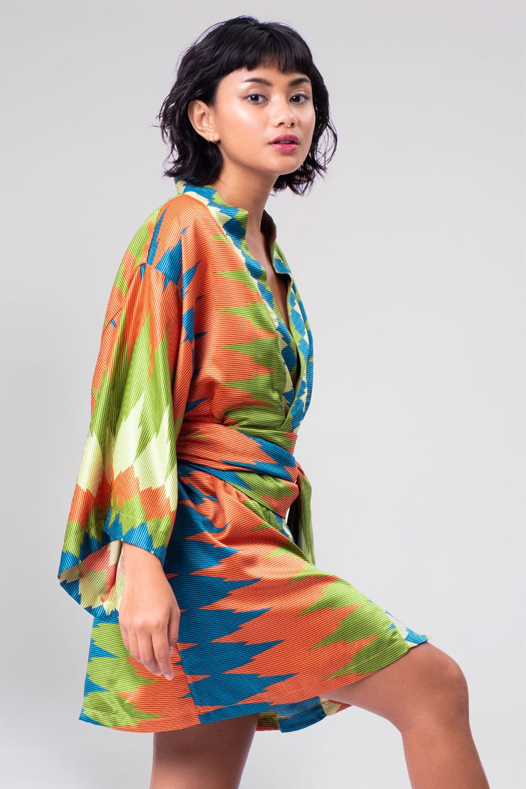 A trendy green and orange geometric short kimono from Rafikimono, highlighting a harmonious fusion of contemporary patterns and timeless grace.