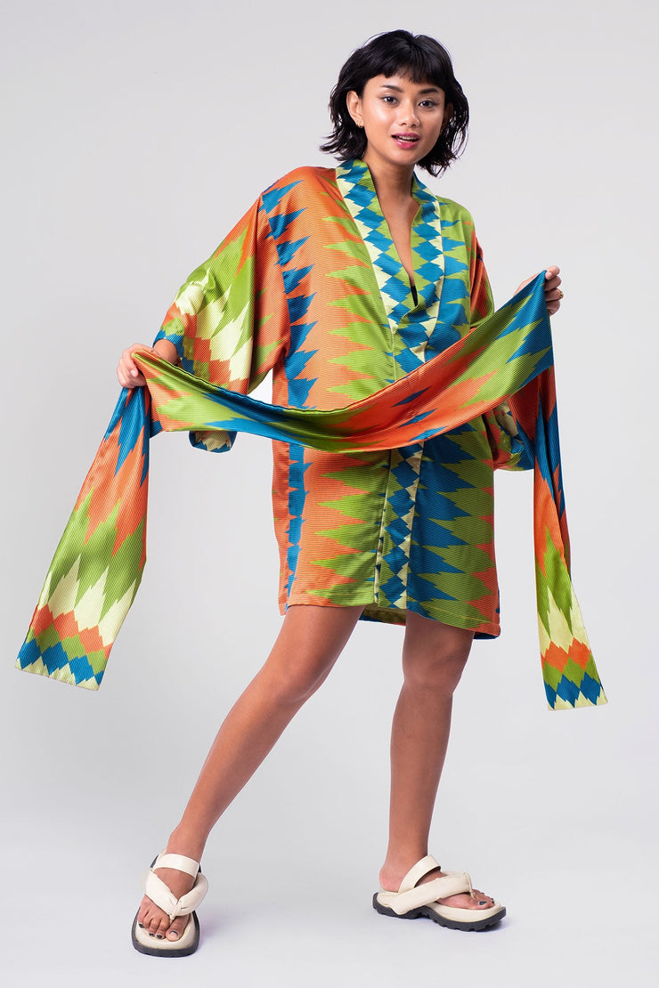 A trendy green and orange geometric short kimono from Rafikimono, highlighting a harmonious fusion of contemporary patterns and timeless grace.
