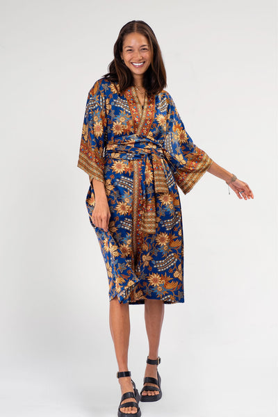 An elegant deep royal blue long kimono caftan, named "Palay" after the rice plant, exuding a sense of regal sophistication and inspired by the rich cultural heritage of rice cultivation in filipino